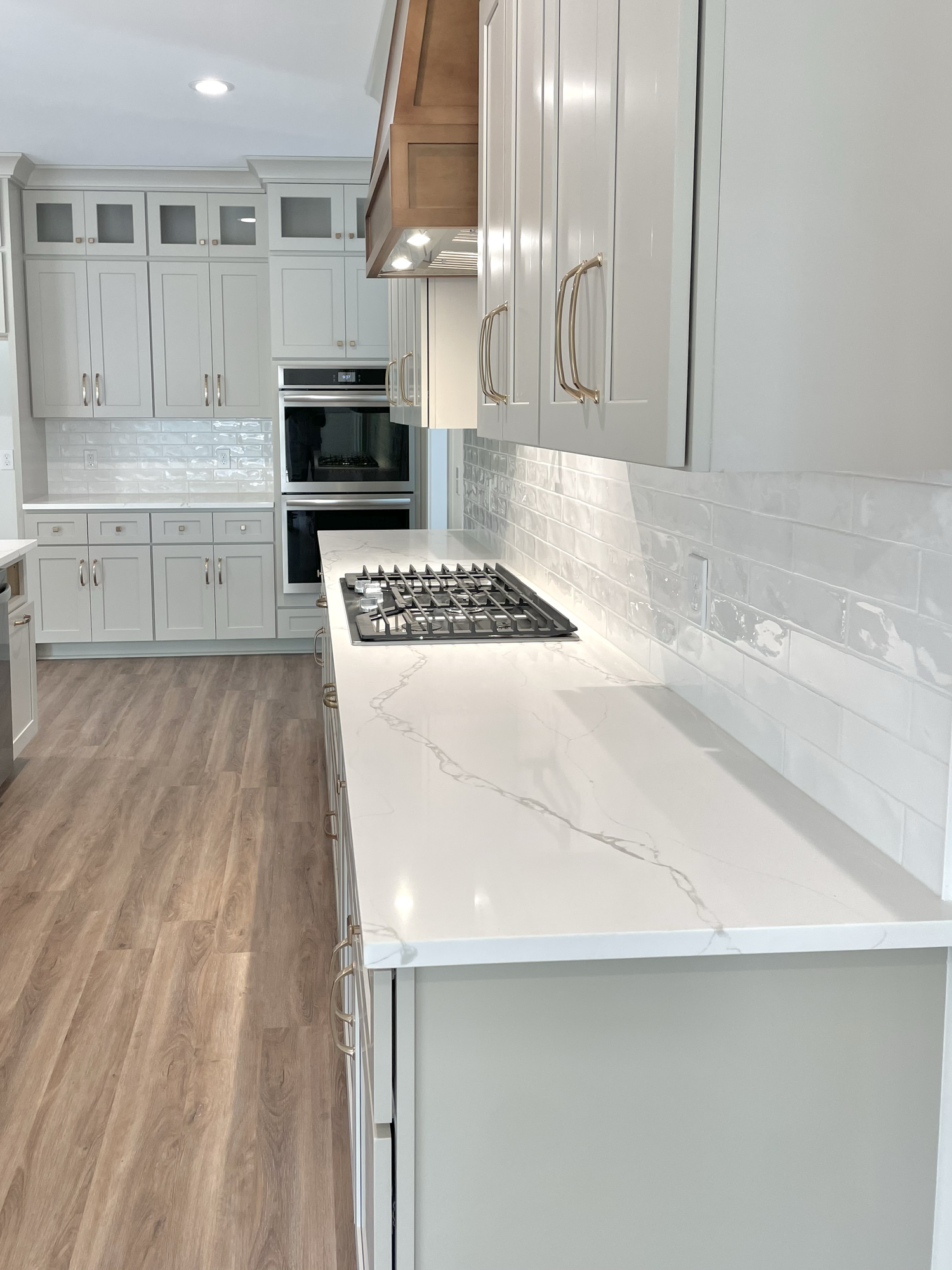 Close view of a light-veined kitchen countertop and cooking area installed by Sondos Stone in North Carolina