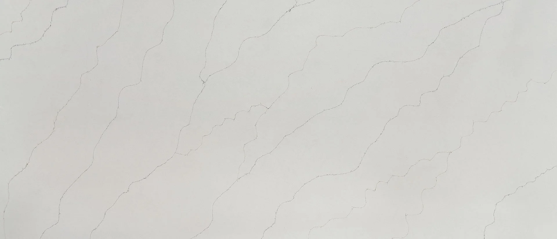 Calacatta Duolina engineered quartz with warm white background and gray gold veins