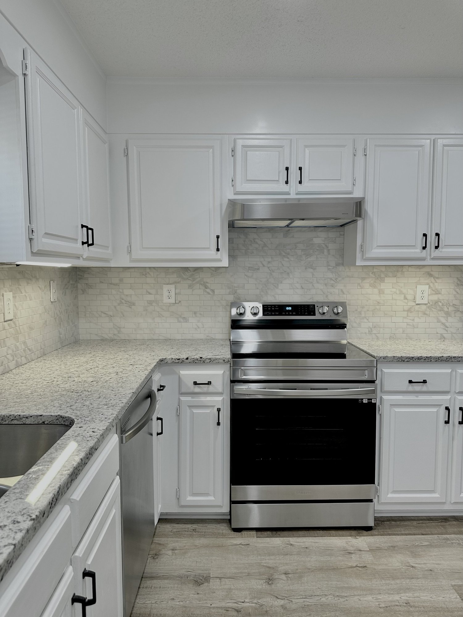 Sondos Stone kitchen with granite counters and white subway tile backsplash