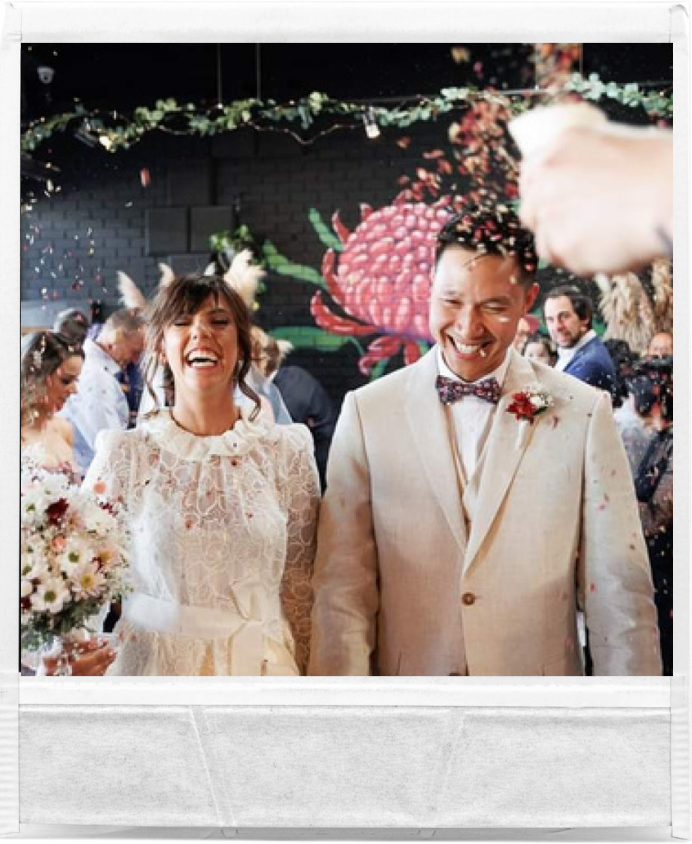 ec and Nick celebrating under confetti at their Northside Wines wedding in Northcote, smiling with joy.
