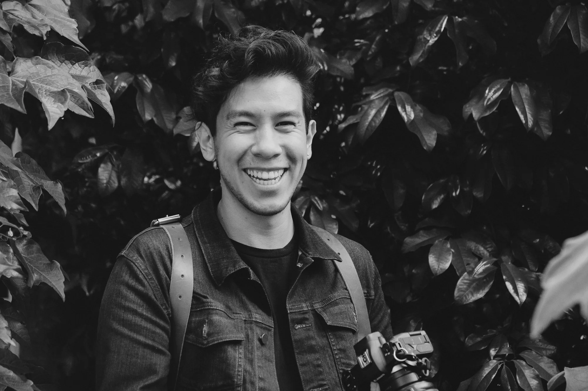 Martin, co-founder of Folkstone, smiling while holding his camera in an outdoor setting.