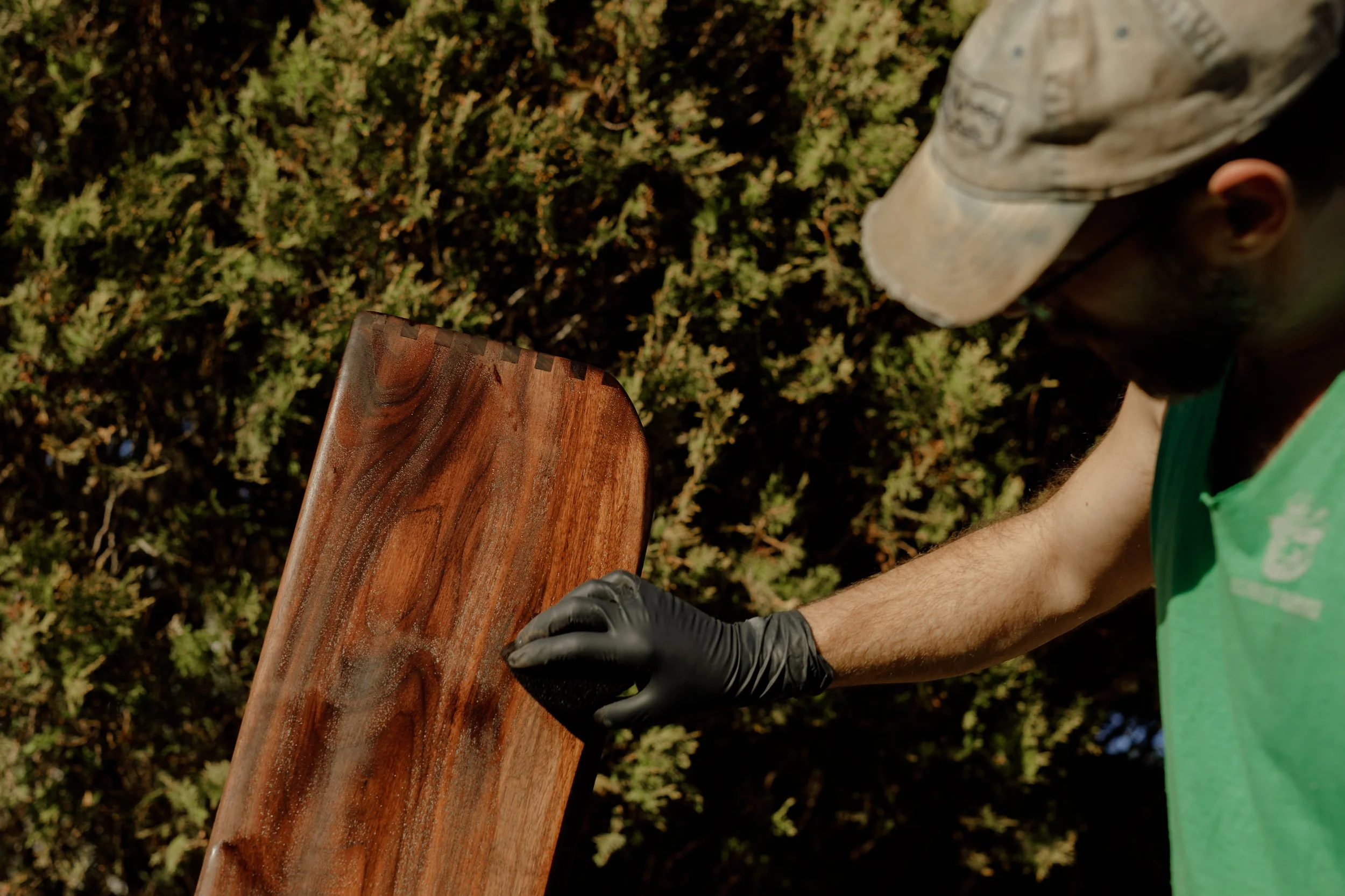 Varnish being applied to wood cabinet