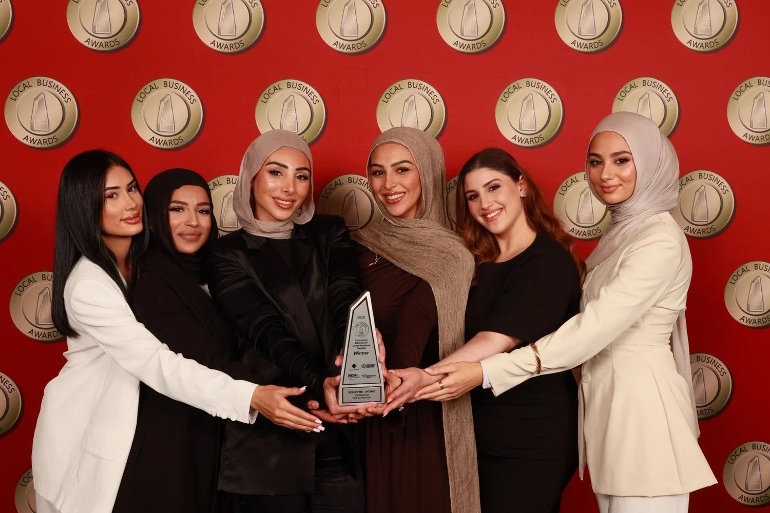 Sculpt Me team receiving the 2026 Local Business Award for Outstanding Beauty Services