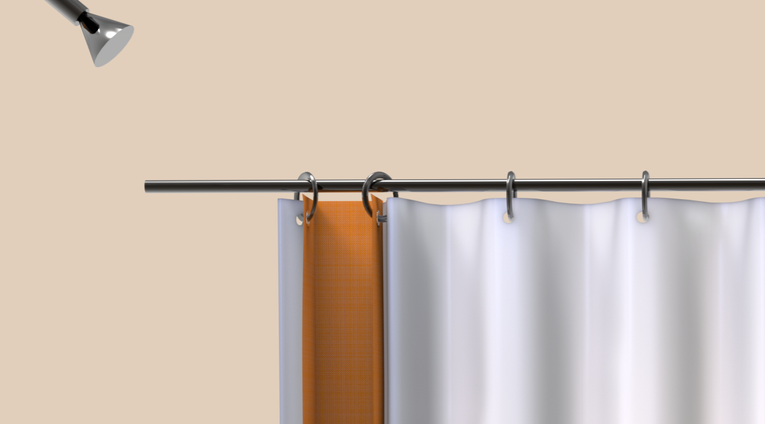 A shower curtain hanging on a rod with a hemp shower caddy.