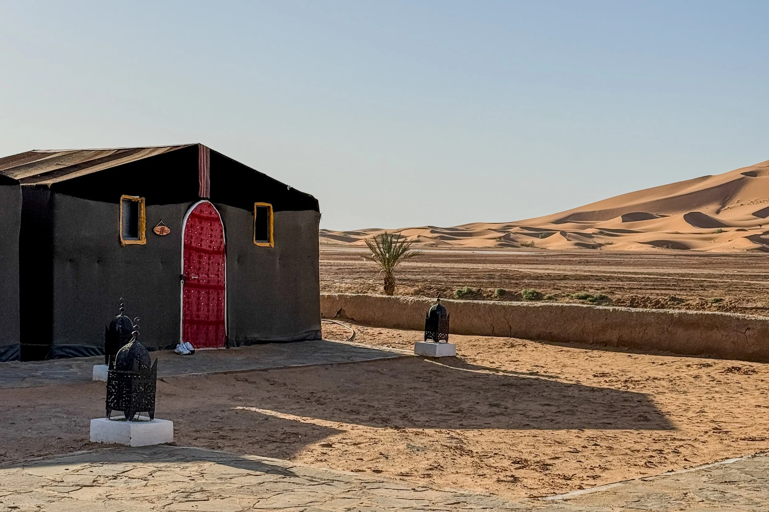 Want with sand dunes in the background at a luxury desert camp in the Sahara Desert in Morocco