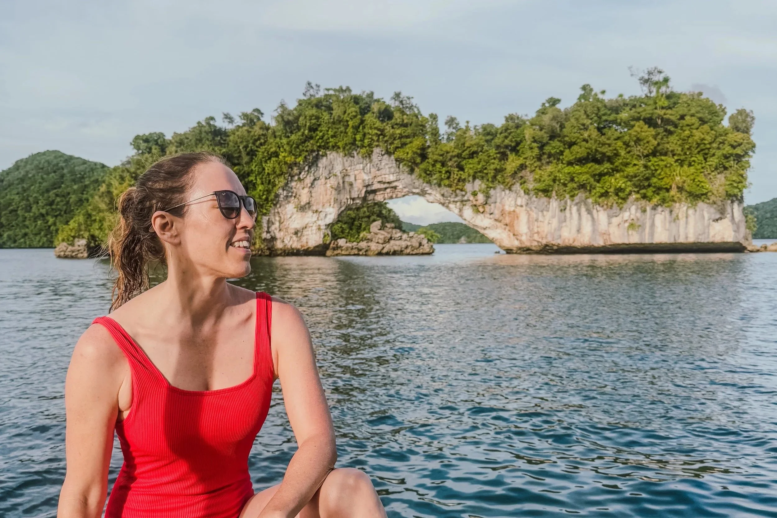 Sitting on a boat in front of the Natural Arch in Palau