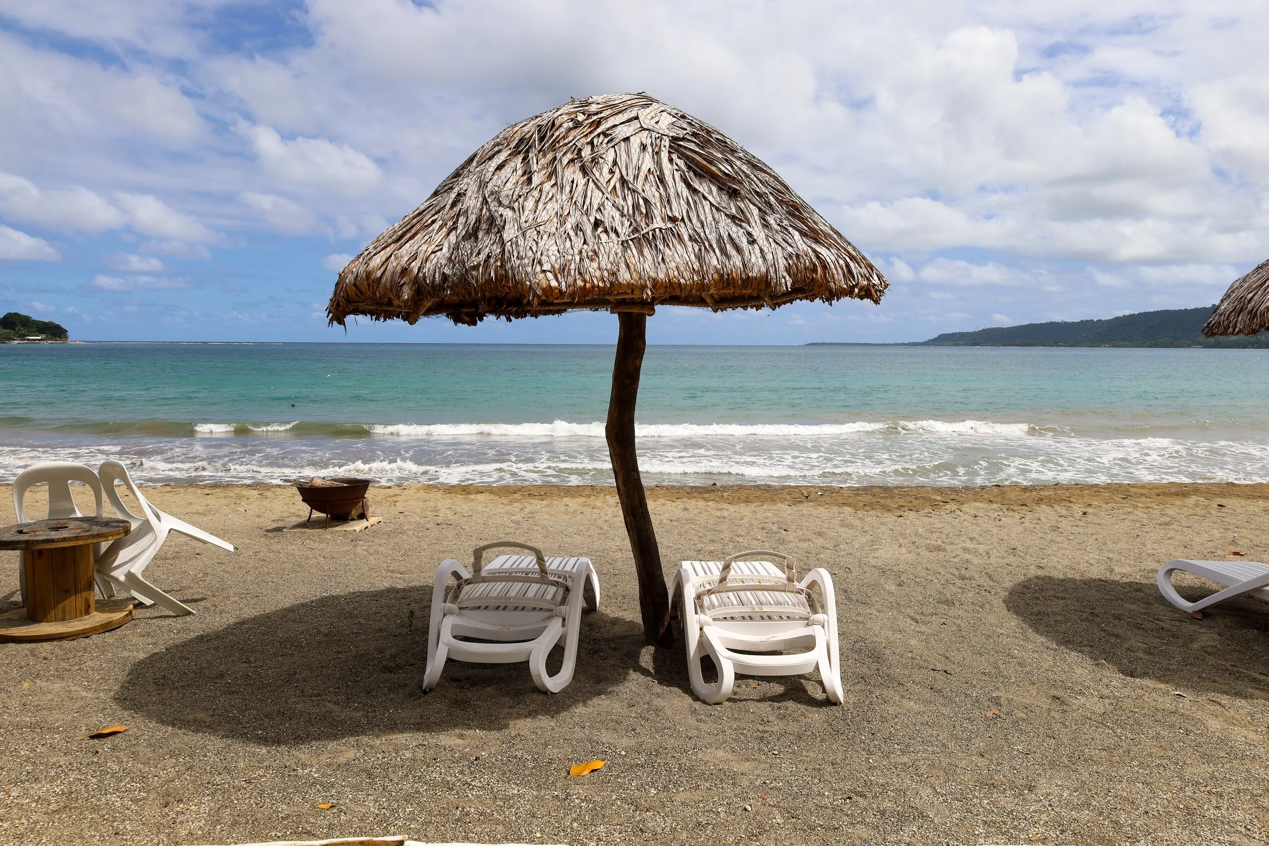 Umbrella on the beach at Mali Beach Club on Efate Island. A great day trip from Port Vila in Vanuatu.