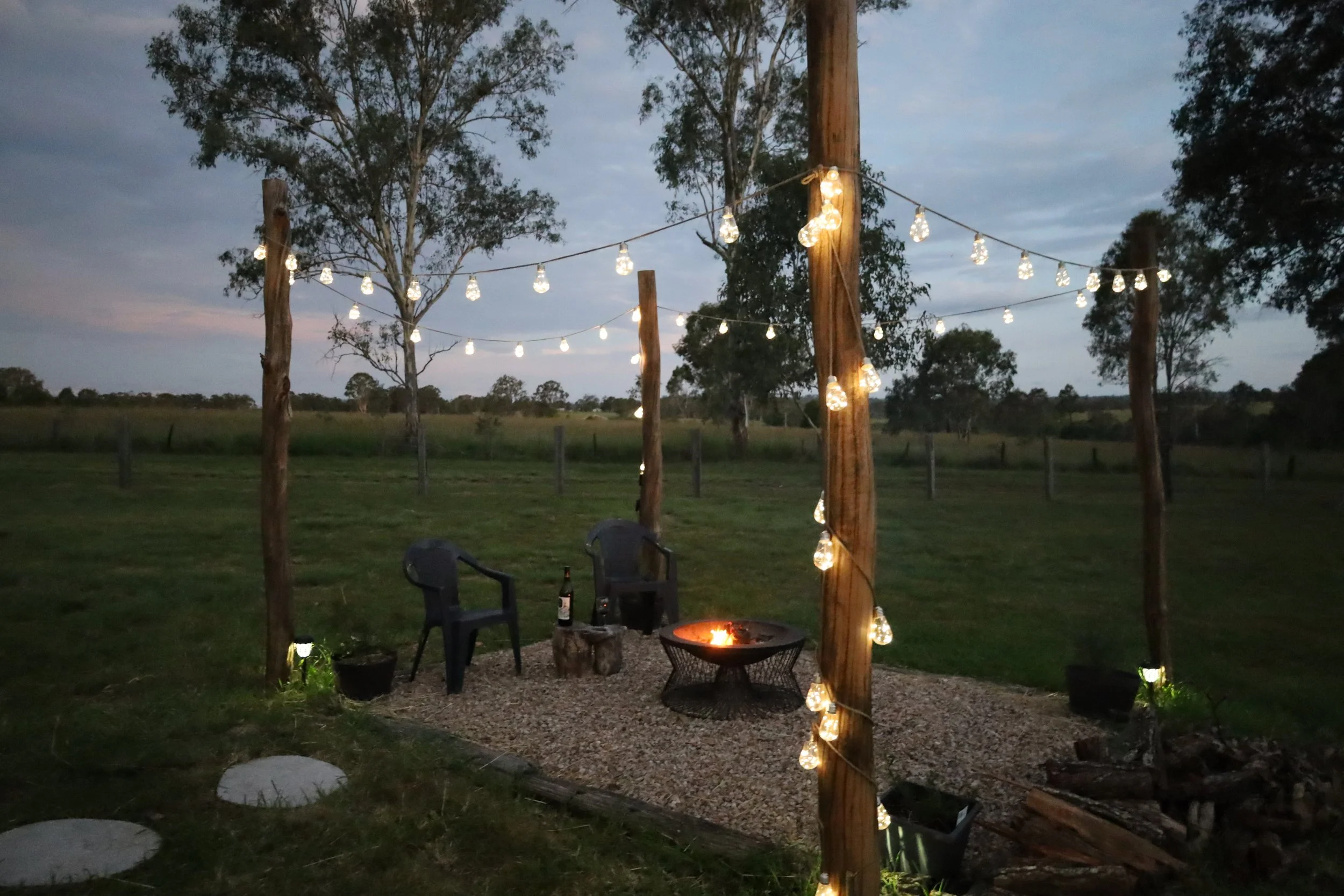 The fire pit with fairy lights at Kalmya Farm Retreat by Tiny Away, Runnymede in South Burnett, Queensland