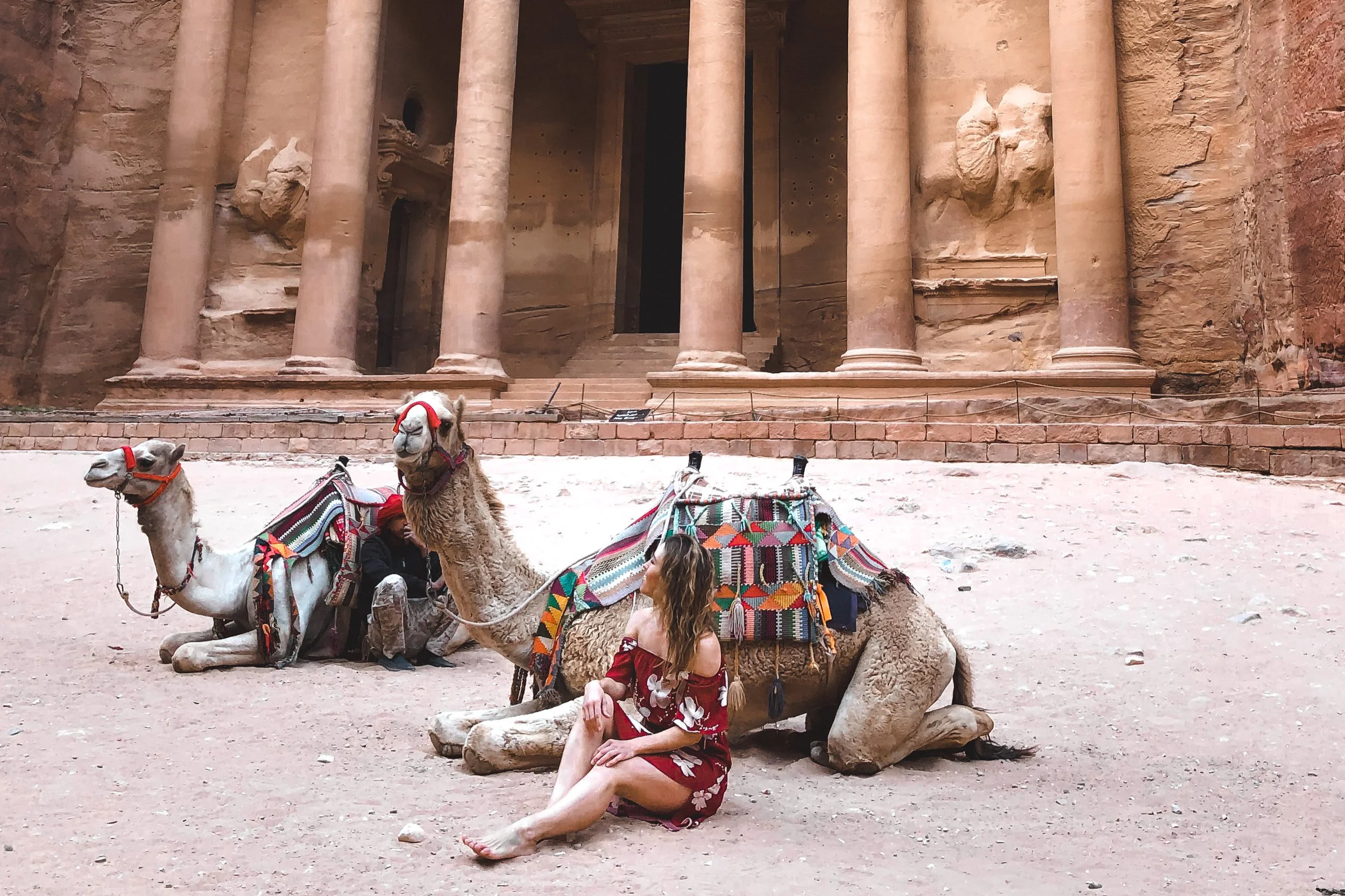 Sitting with camels at the Treasury in Petra, Jordan