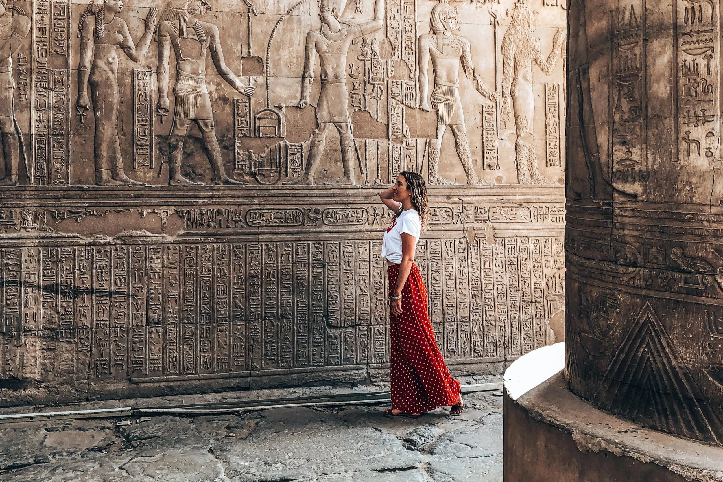 Walking in front of hieroglyphics in Egypt
