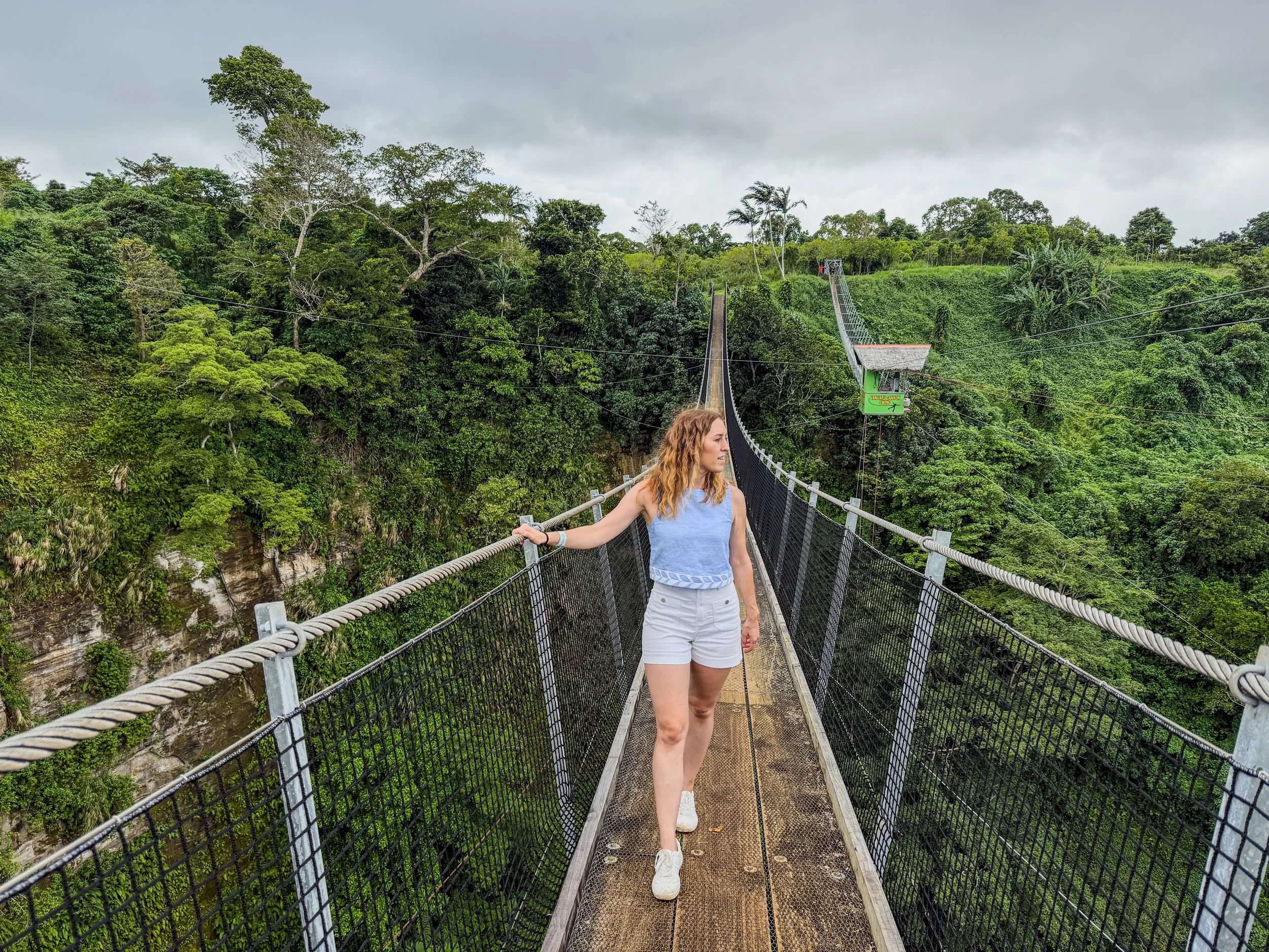 Walking across the sky bridge at Vanuatu Zipline on Efate Island.