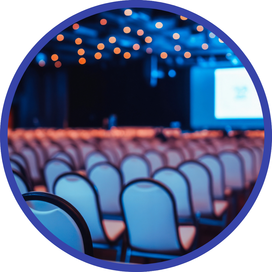 Empty conference room with rows of chairs facing a presentation screen.