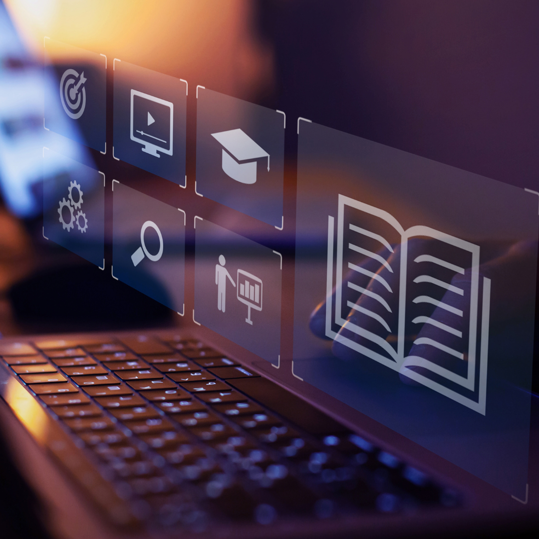 Digital learning icons displayed over a laptop keyboard, representing instructional content creation.
