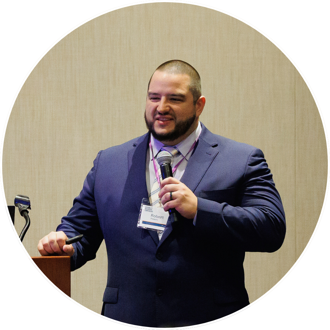 Coursing Justice speaker presenting at a podium, holding a microphone during a professional conference session.