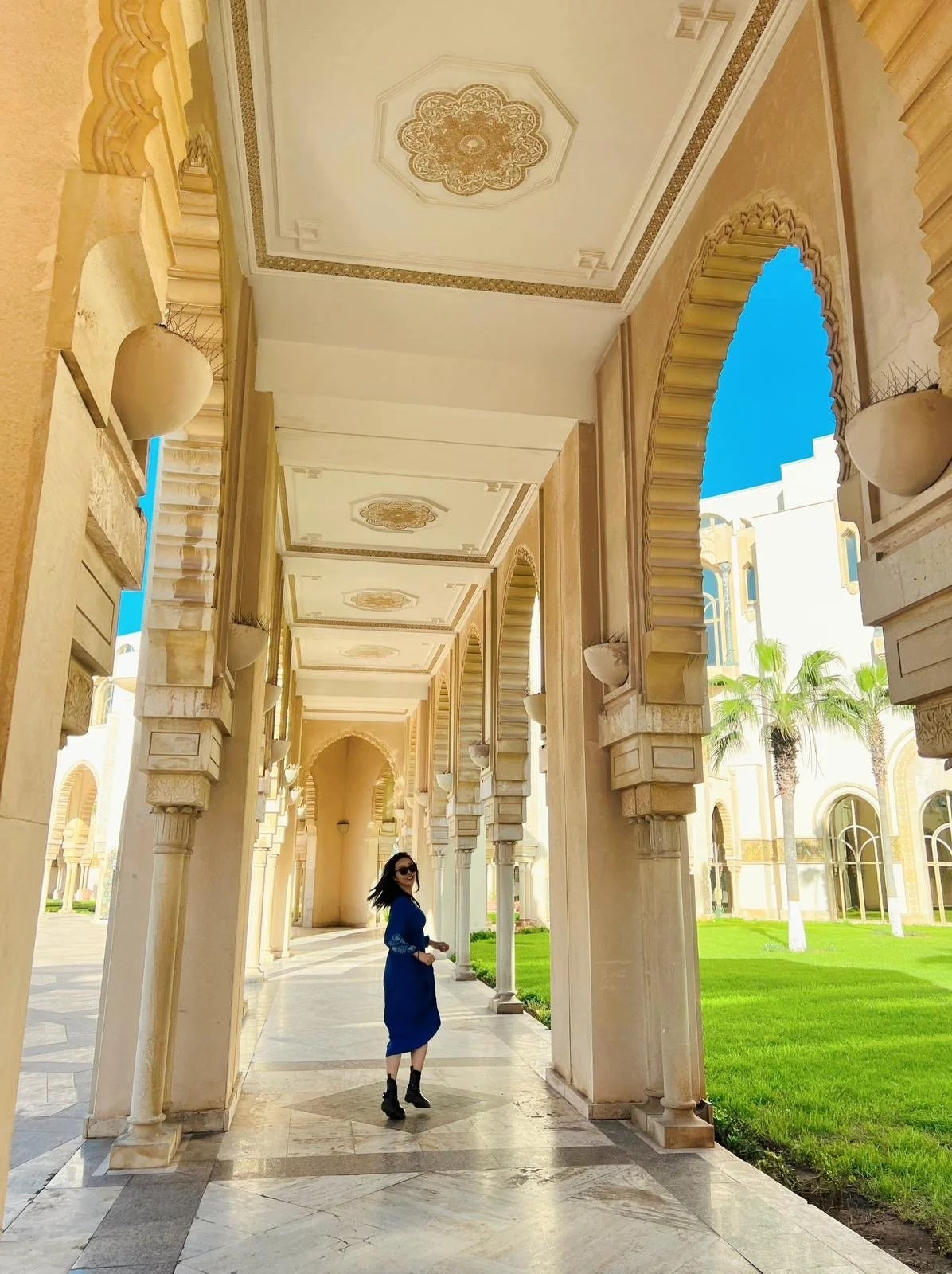 The Hassan II Mosque in Casablanca, Morocco, featuring a tall minaret, intricate tile work, and a spacious courtyard under a clear blue sky.
