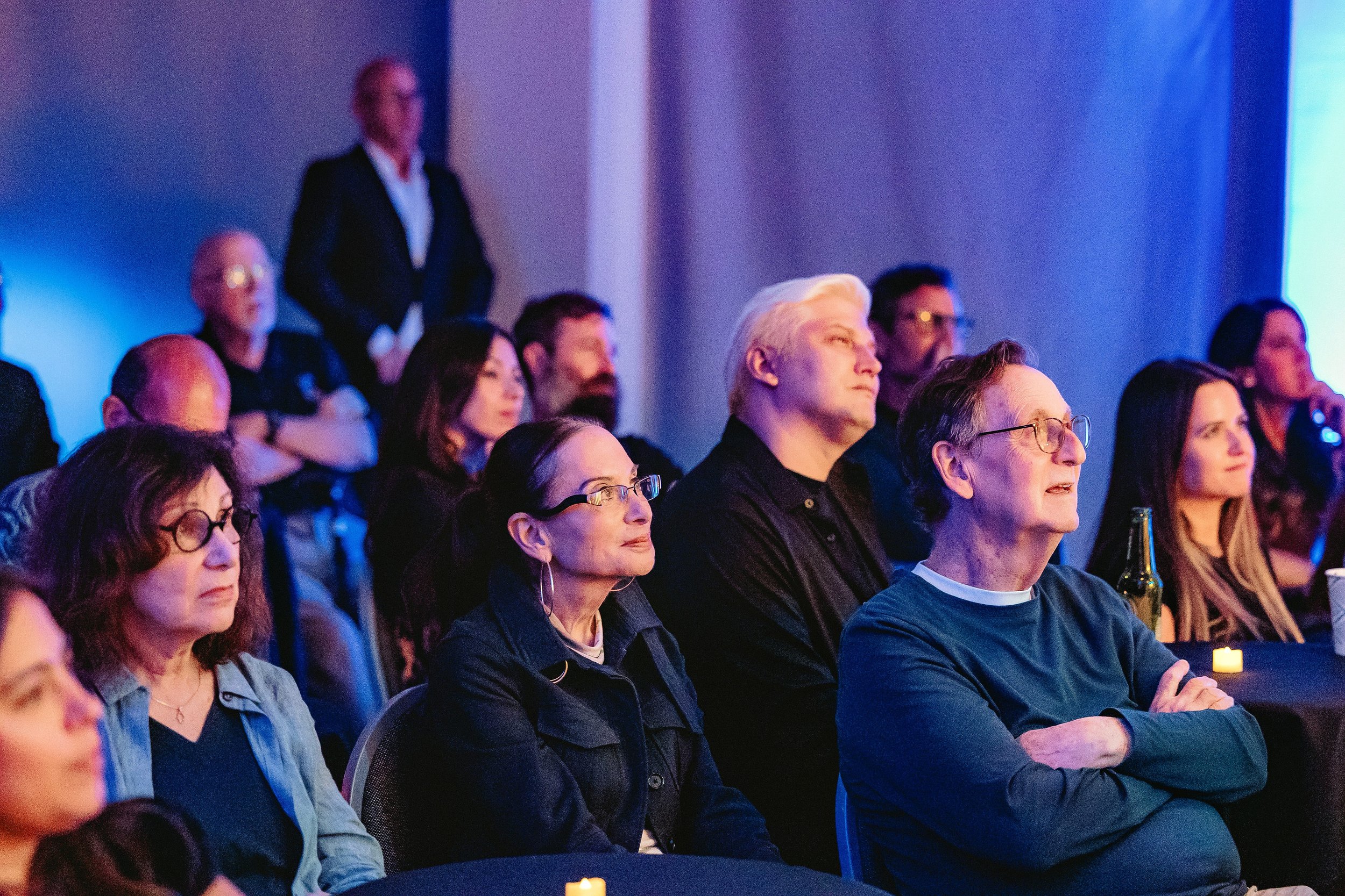 Guests watching and reacting to a live performance at a Miami event.