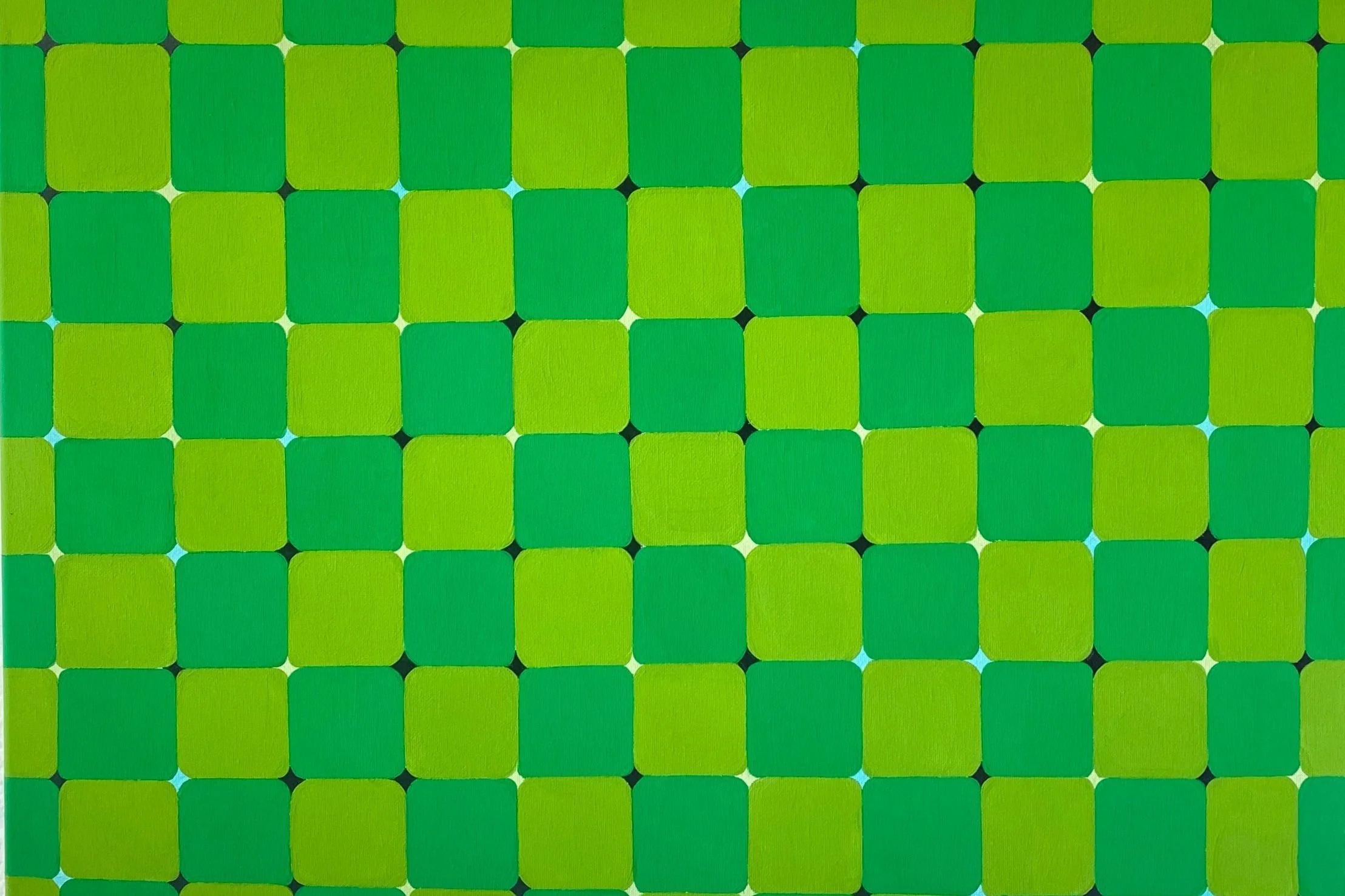 A pattern of green squares with rounded corners arranged in a grid on a metallic surface.