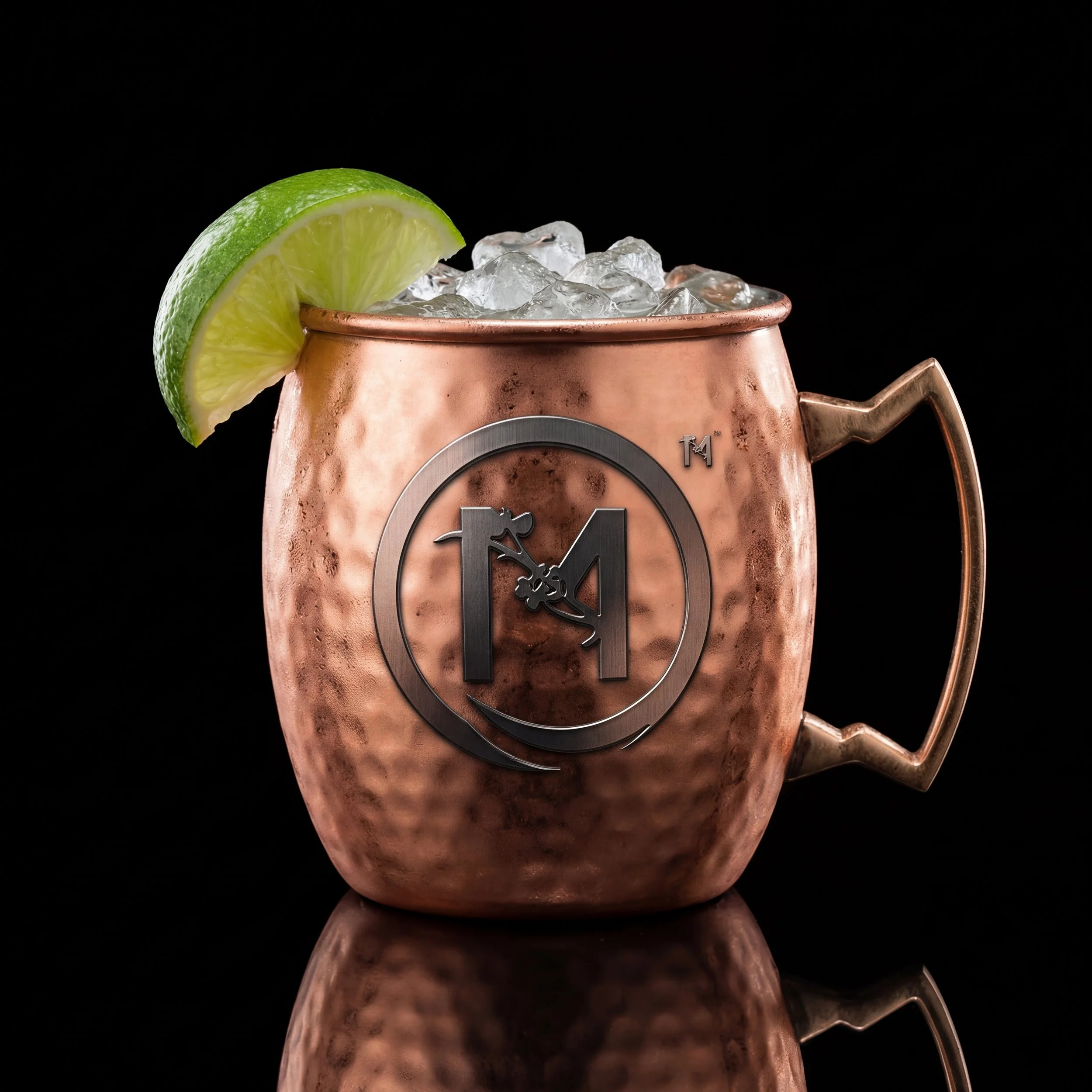 A frosty copper mug filled with Mito's refreshing Mule Two Ways, expertly mixed with premium liquor, spicy ginger beer, and garnished with a fresh lime wedge