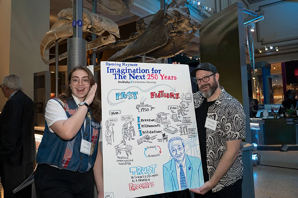 Peter and Lillian Durand pose with visual notes from the opening keynote.