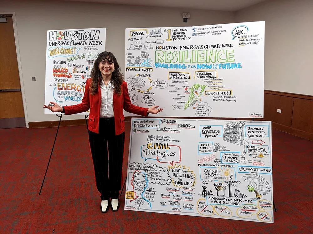 A woman wearing a red velvet jacket, white shirt, black slacks, and white boots posing with graphic recording from Houston Energy & Climate Week.