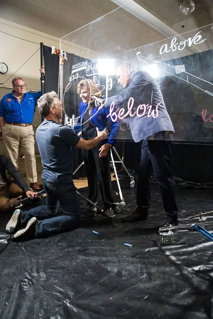 Photographer Asa Mathat positions Dr. Sylvia Earle for her portrait.