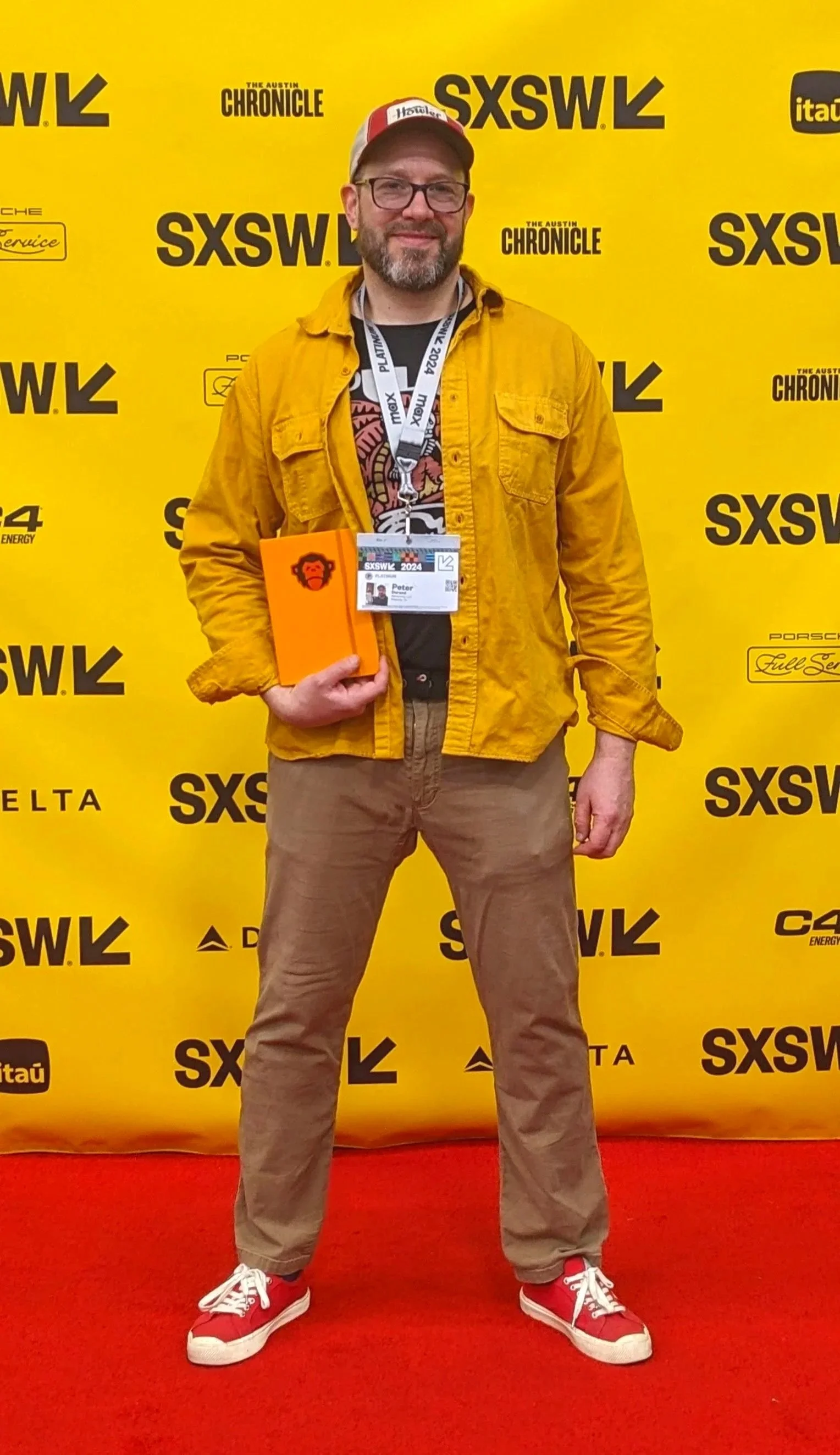 Peter Durand at SXSW wearing a yellow jacket and notebook