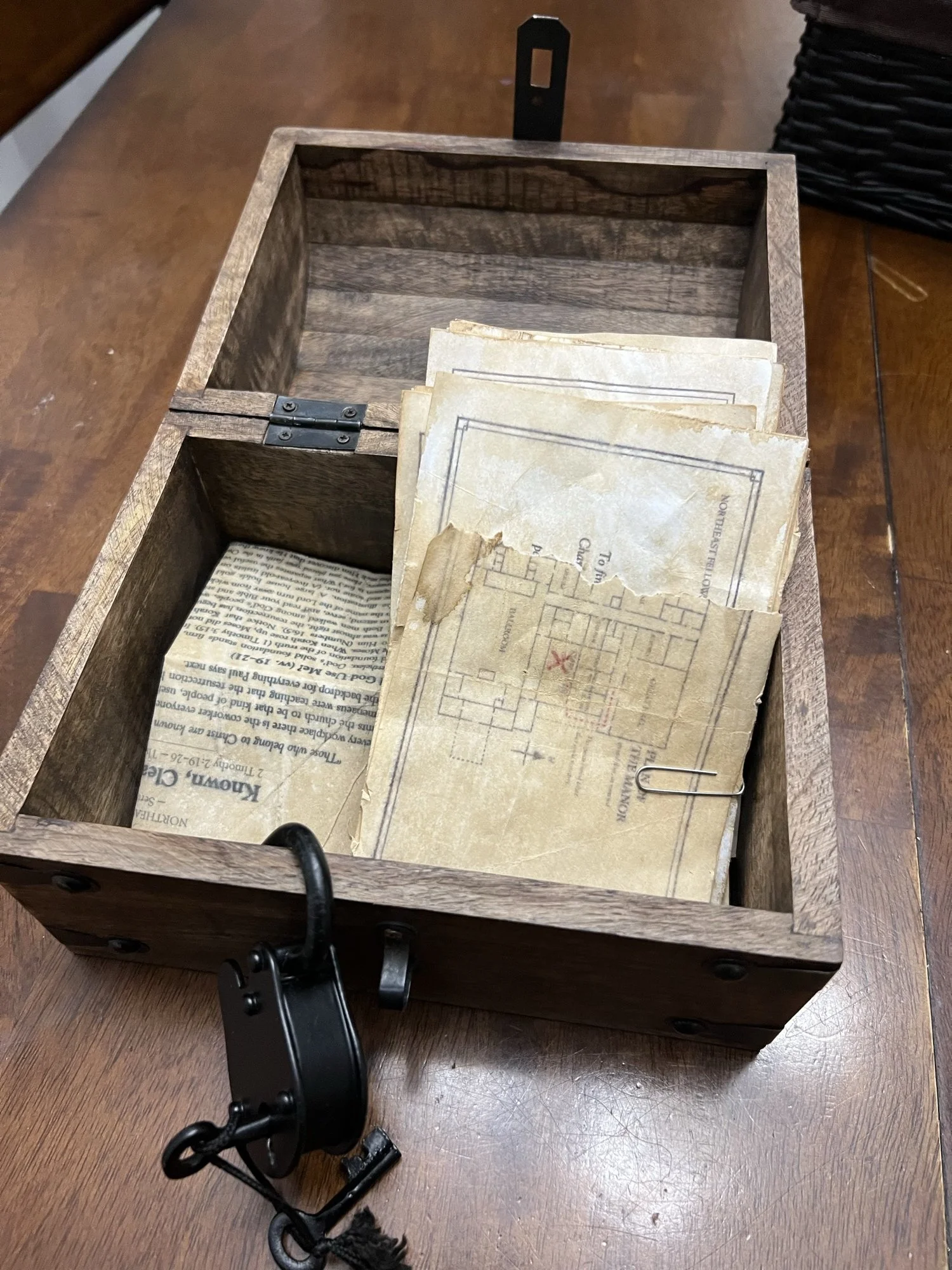 Wooden chest holding old maps and clue papers for the Clue-themed Late Night