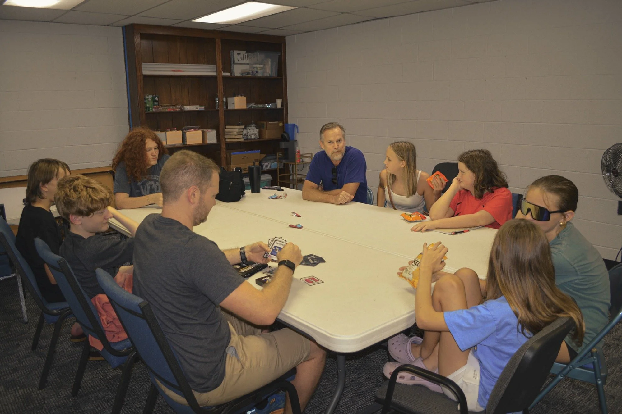 NEF Youth students and leaders gathered around a table