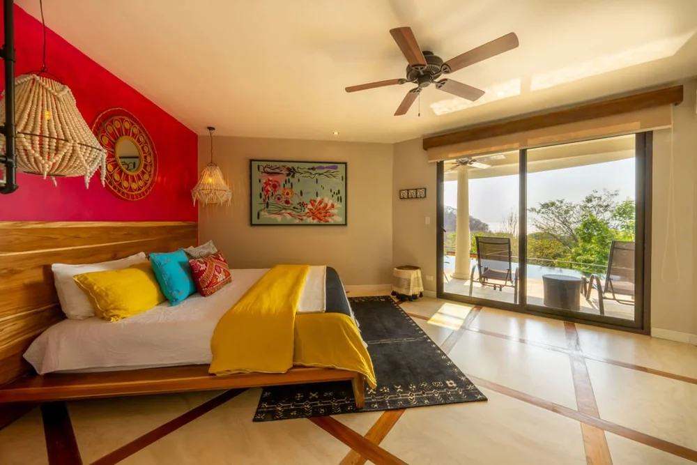 The Mariposa Deluxe Suite, with a king bed and a view of the pool