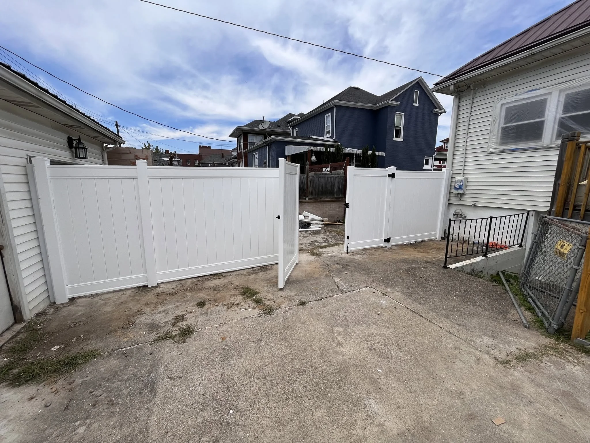 gate on a white vinyl fence