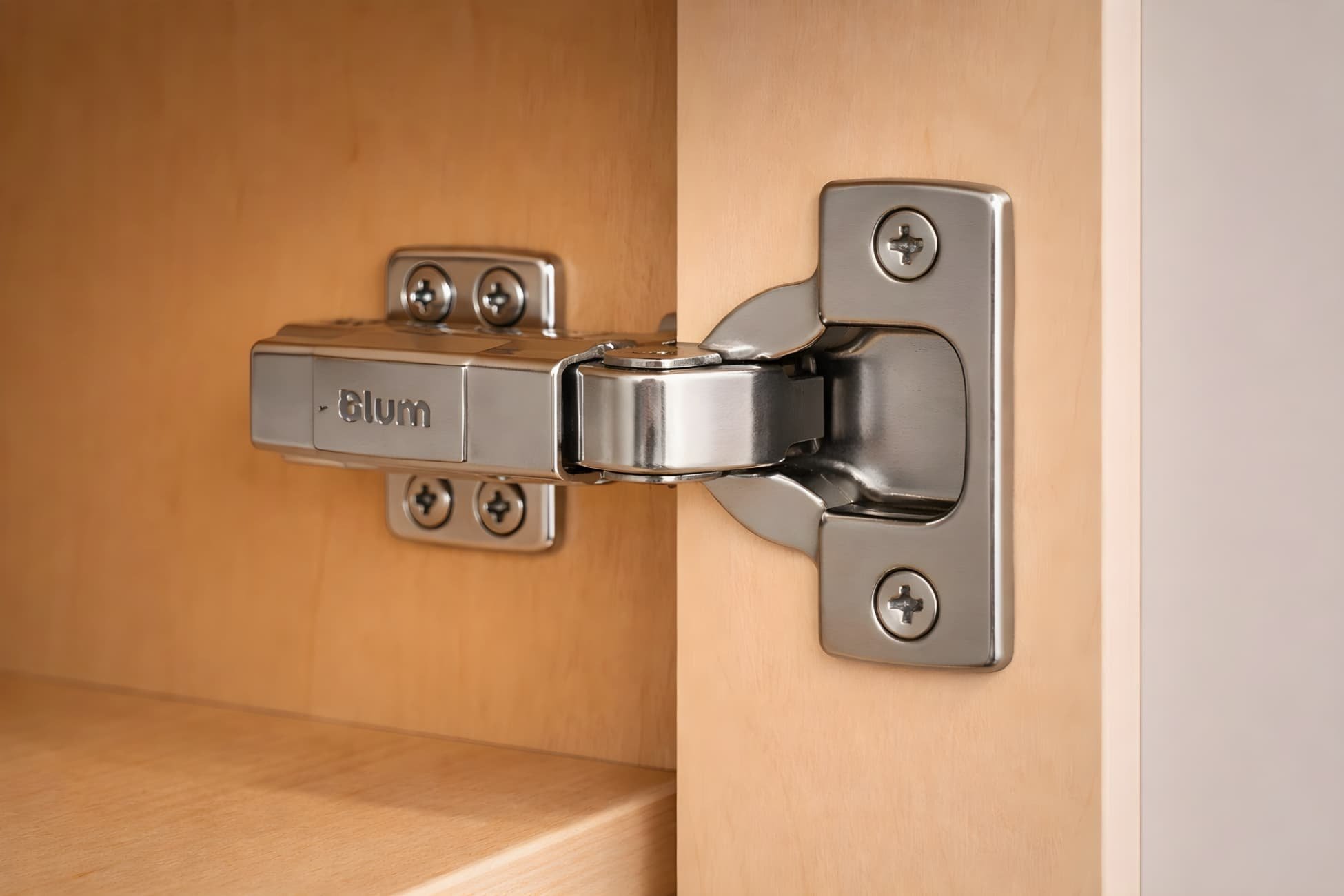 Blum soft-close cabinet hinge installed inside a luxury kitchen cabinet showing smooth, durable door operation and premium hardware construction