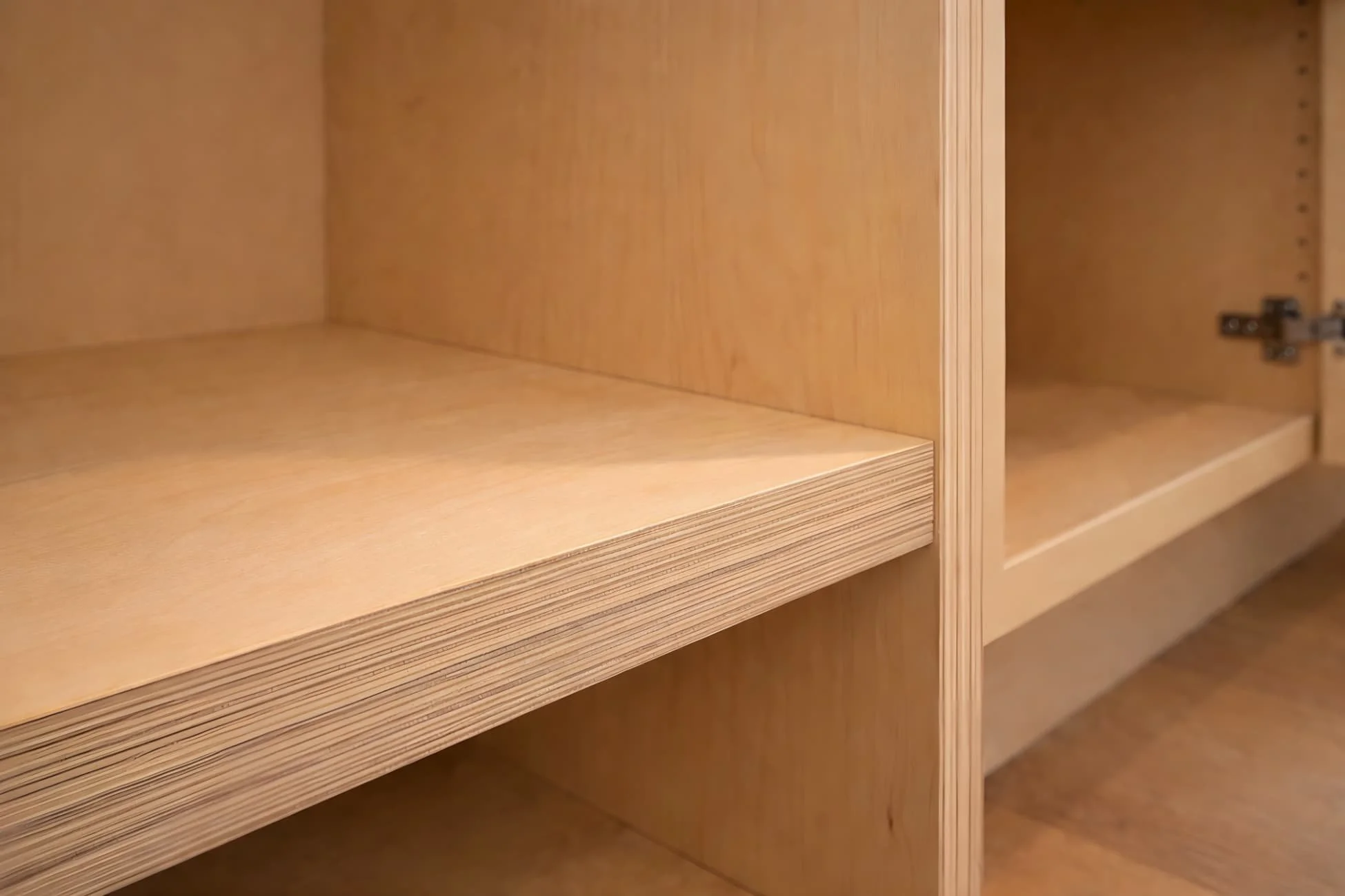 Plywood cabinet box interior showing layered wood construction with clean joinery for strength, stability, and long-term durability in luxury kitchen cabinetry