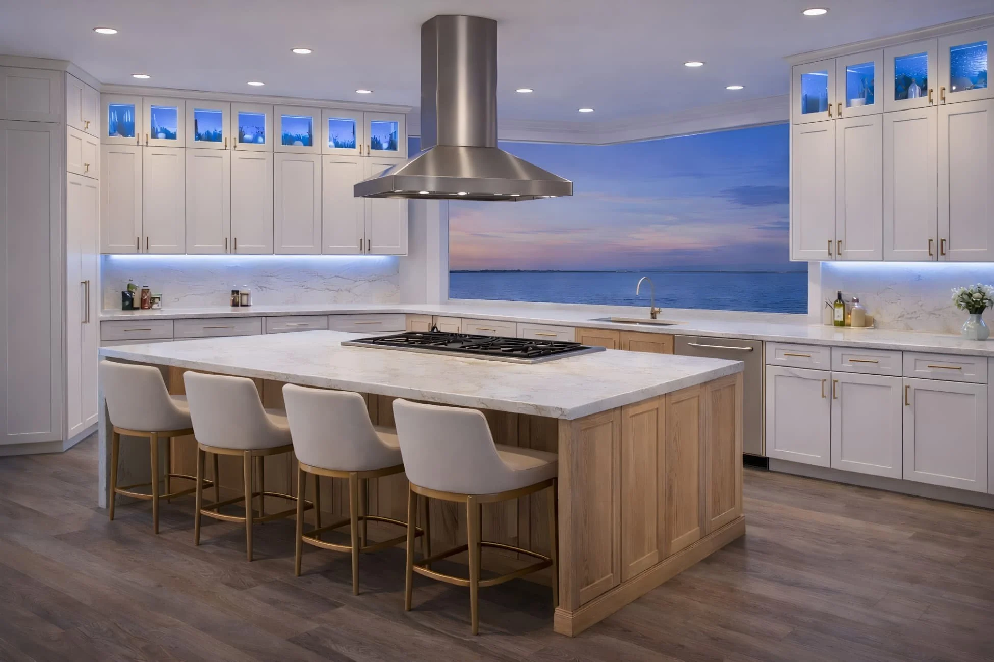 Catalina Collection kitchen with Polar White shaker cabinets, Sandstone white oak island, glass uppers with blue LED lighting, and coastal ocean view.