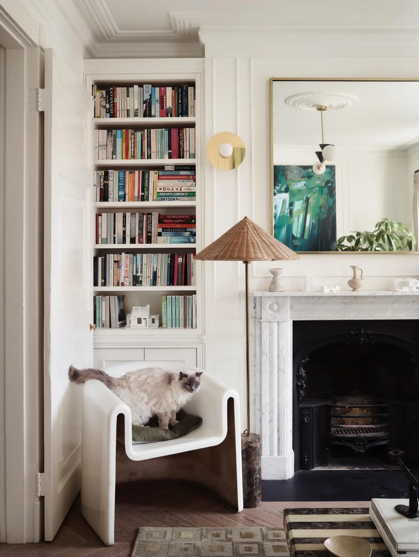Before we renovated this house, this room was a collection of small details that caused daily frustration.

Plastic floors with exposed edges that cut your feet so you could never walk barefoot. A fireplace with no original surround, just an awkward 