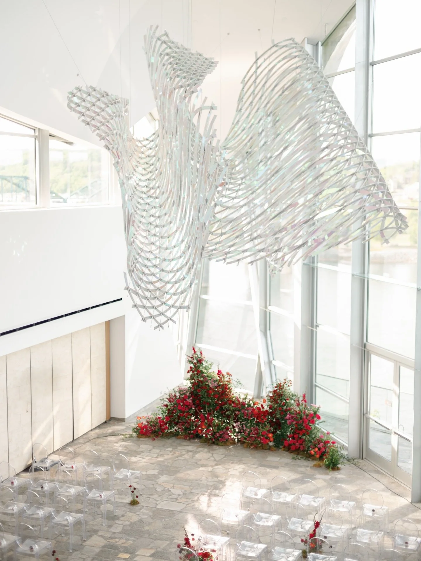 Temporary installation of flowers under the undulated permanent sculpture at @huntermuseum . One of my favorite ceremony setups ever thanks to an inspiring location, a bold color palette, and endless trust from my client to create something unique an