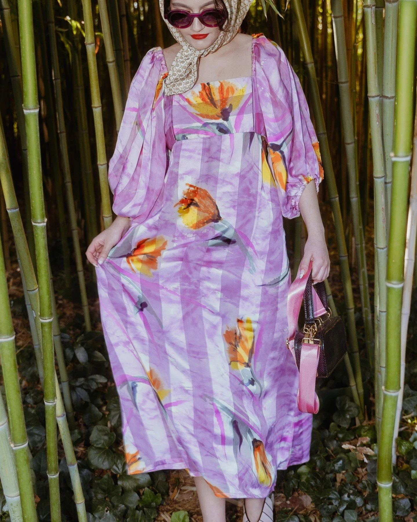 A queen turns a walk through the bamboo groves into a high-fashion scene. The moment is defined by the pure style of presence, where vibrant silk and floral patterns cut through the natural green backdrop to create something truly iconic. 

This is R