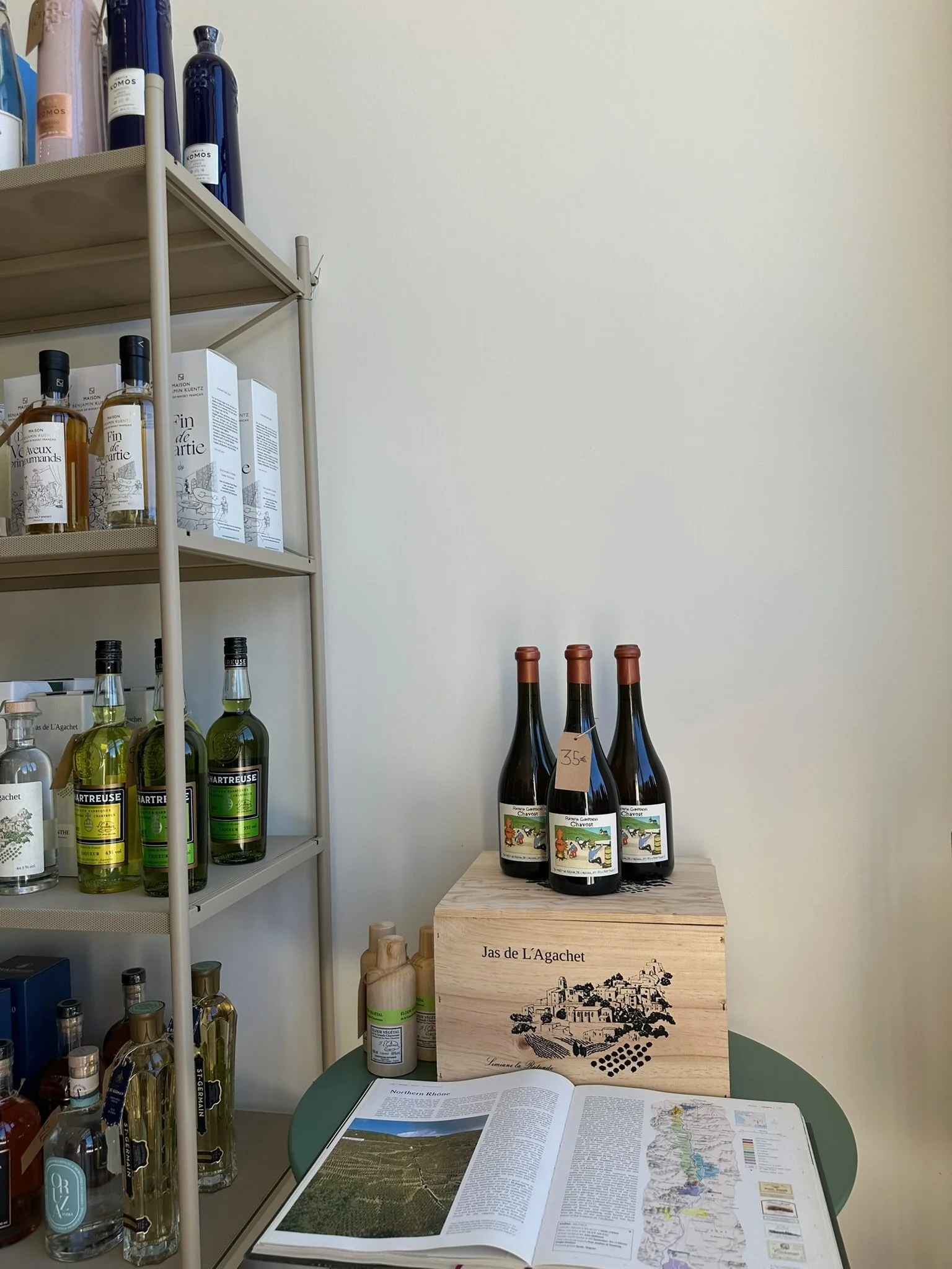 Carefully selected bottles of natural wine on the shelves of Racines, an independent wine shop in Bonnieux, Provence.