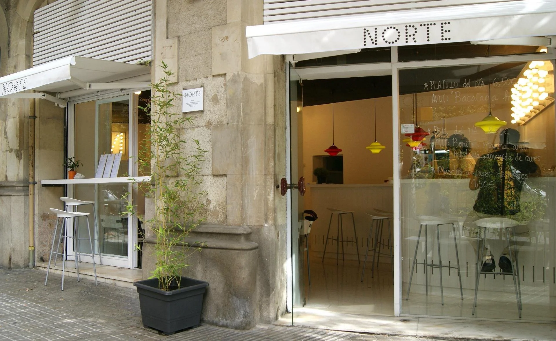  Norte  

 A neighborhood staple serving Basque and Galician classics made with fresh, local ingredients.  Keep an eye out for their daily specials! 

  P : This is my perfect outdoor Barcelona dining experience: fresh, local dishes at a reasonable p