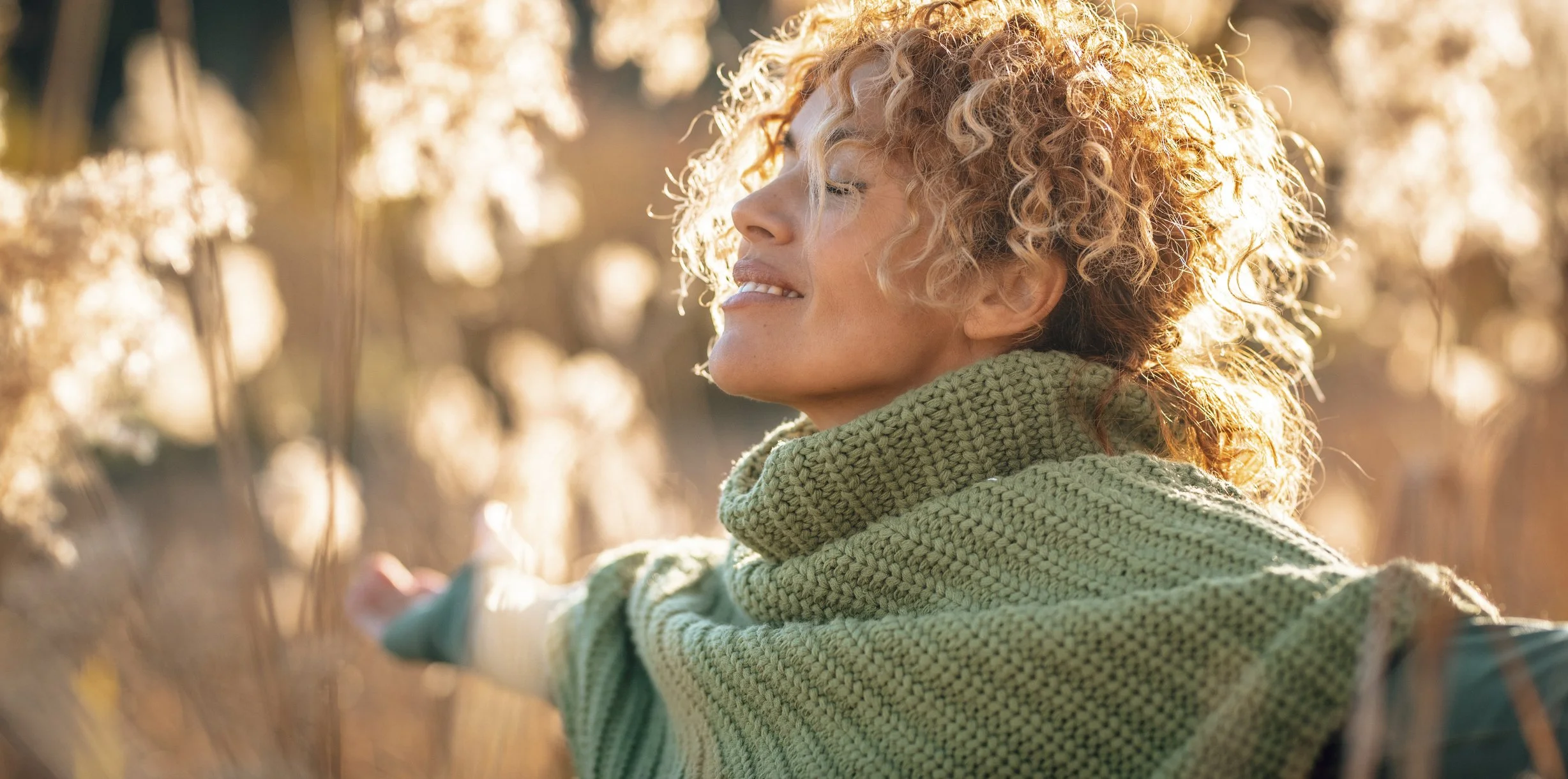 Woman at peace outdoors in warm light, reflecting the calm, reassuring care of colposcopy services in Boise, Idaho