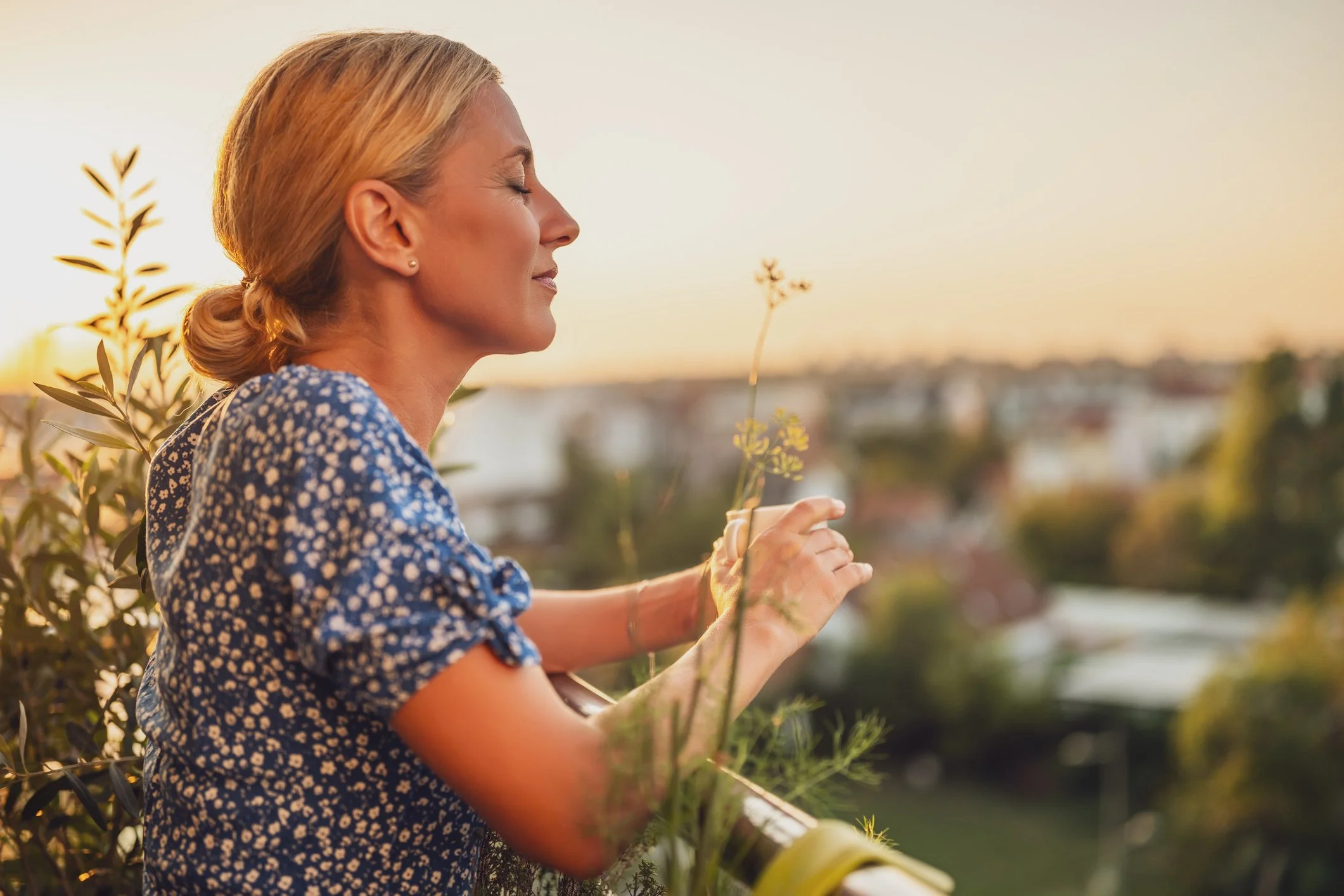 Woman at peace outdoors at sunset, reflecting the calm, supportive care of LEEP procedures in Boise, Idaho
