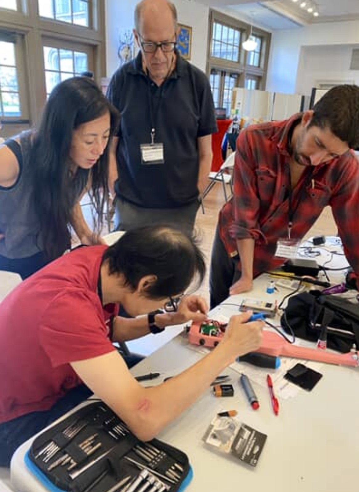 Volunteers and community members sewing and repairing textiles at Repair Café El Barrio in East Harlem