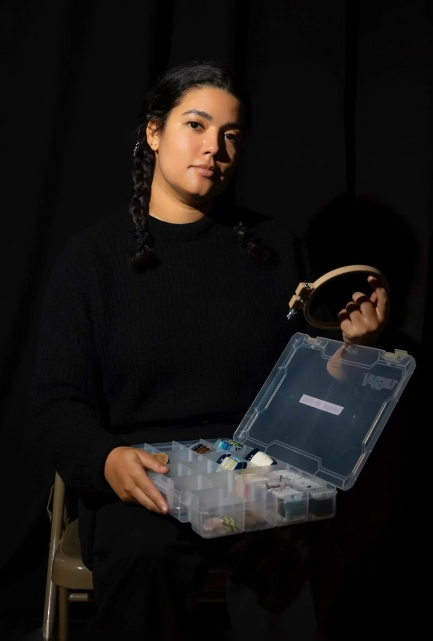 Taylor Behnke Repair Cafe El Barrio repair coach, showing her darning materials at Repair Cafe El Barrio