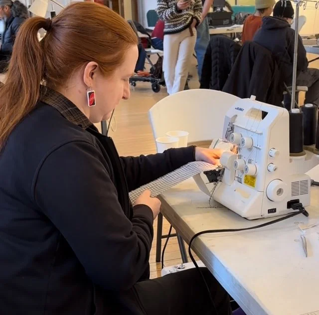 Susan Graves, volunteer at Repair Café El Barrio, using the serger