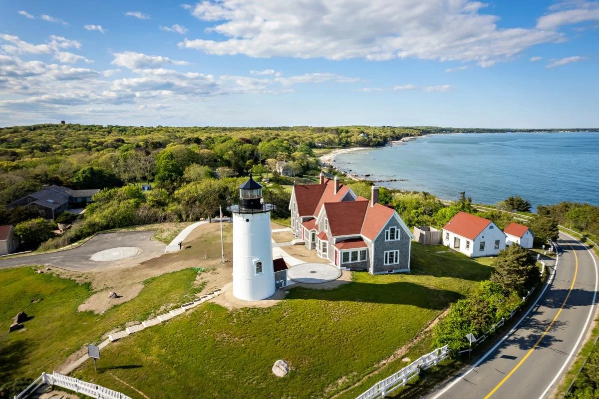 Cape Cod lighthouse overlooking the beach and ocean, symbolizing local charm, trust, and connection in coastal branding.
