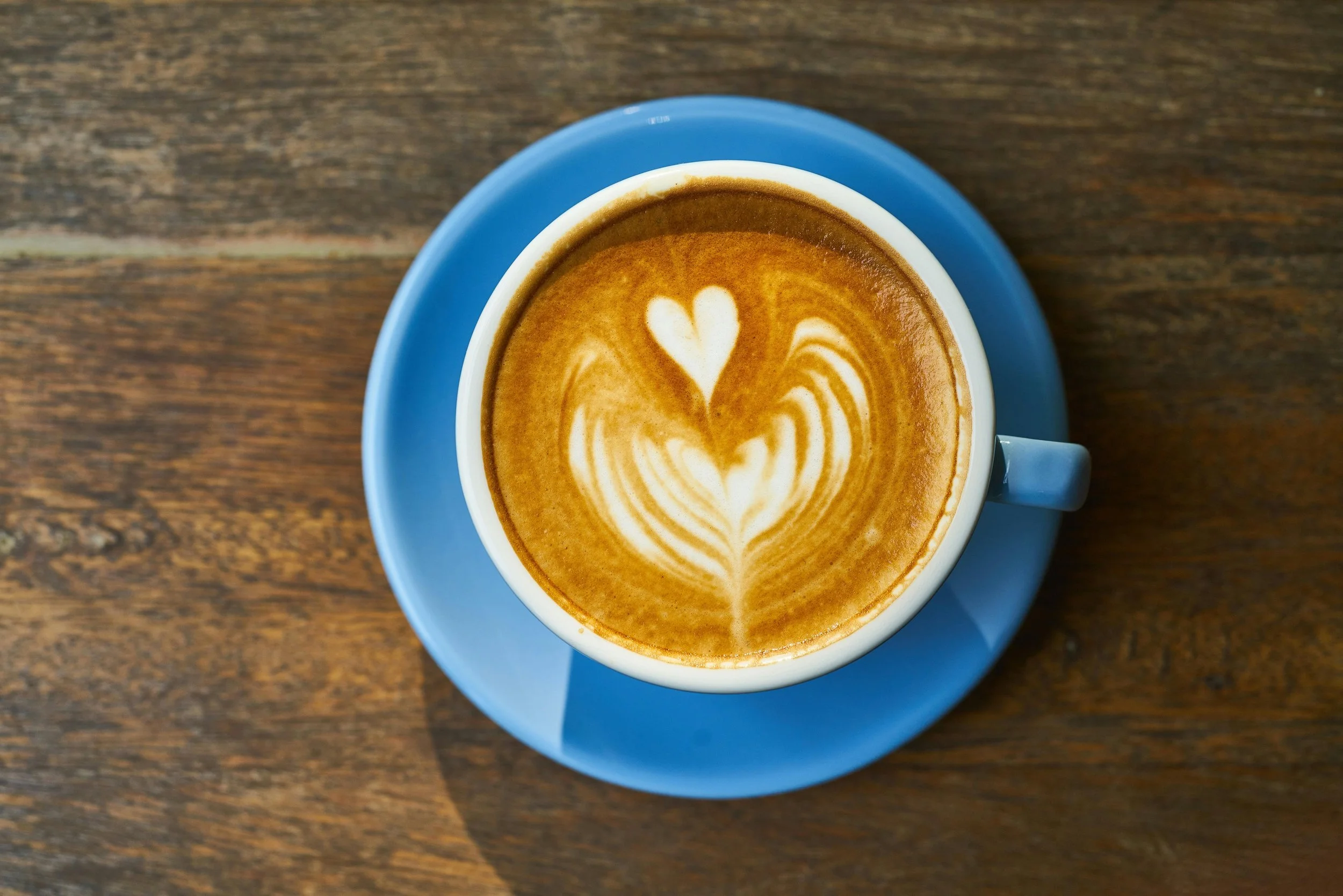 Cup of coffee with heart-shaped cream art, symbolizing warmth, care, and emotional connection in branding.