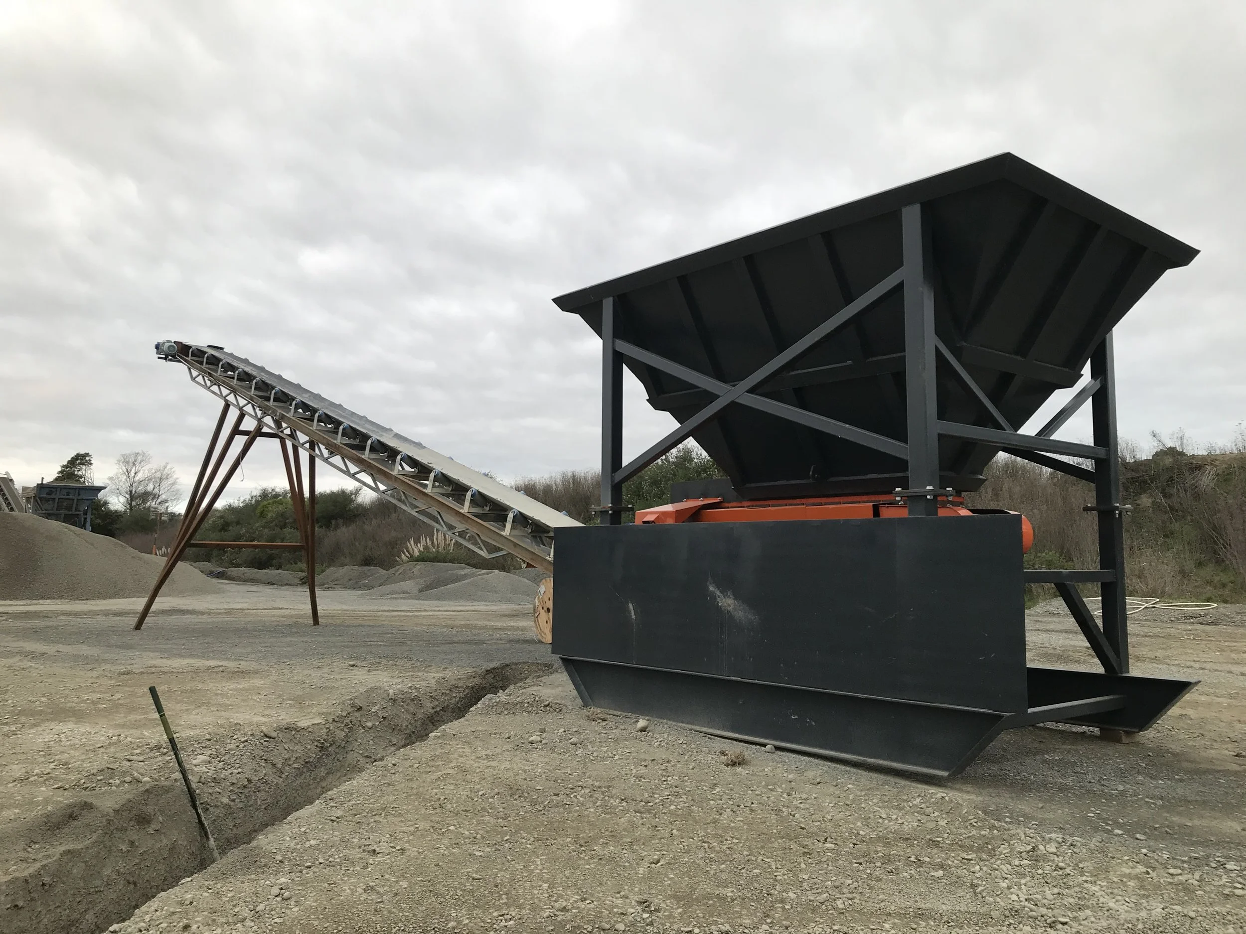Construction site with large machinery and an overcast sky.