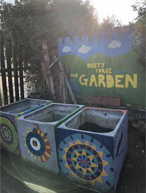 Beautiful hand painted metal composting bins underneath a wintery setting sun at the Dusty Forge community garden in Cardiff
