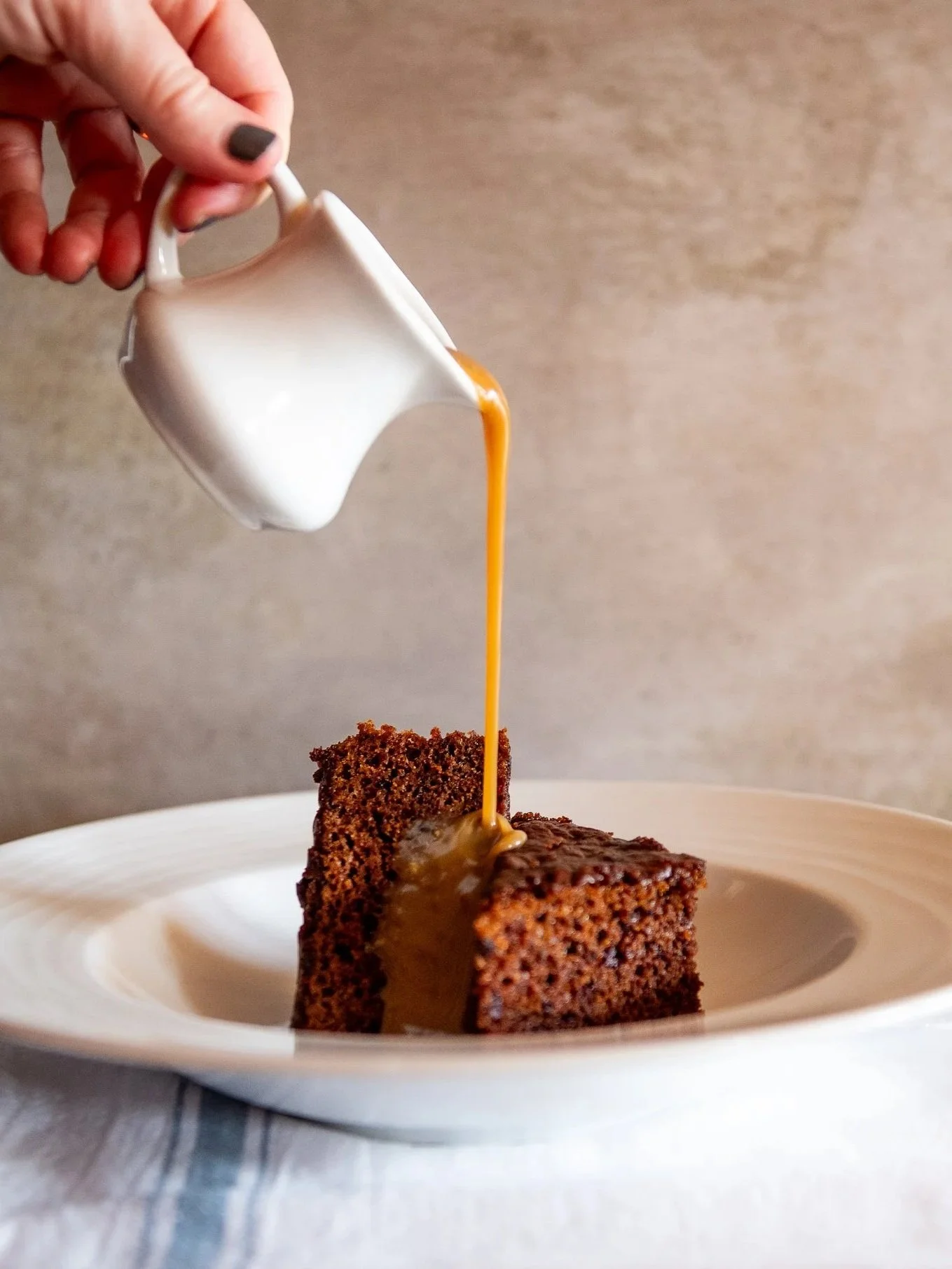 Sticky Toffee Pudding Calypso Grill, iconic Sticky Toffee Pudding Grand Cayman, famous dessert Cayman Islands, Calypso Grill dessert, best Sticky Toffee Pudding Cayman, classic British dessert Caribbean, must eat dessert Grand Cayman restaurant