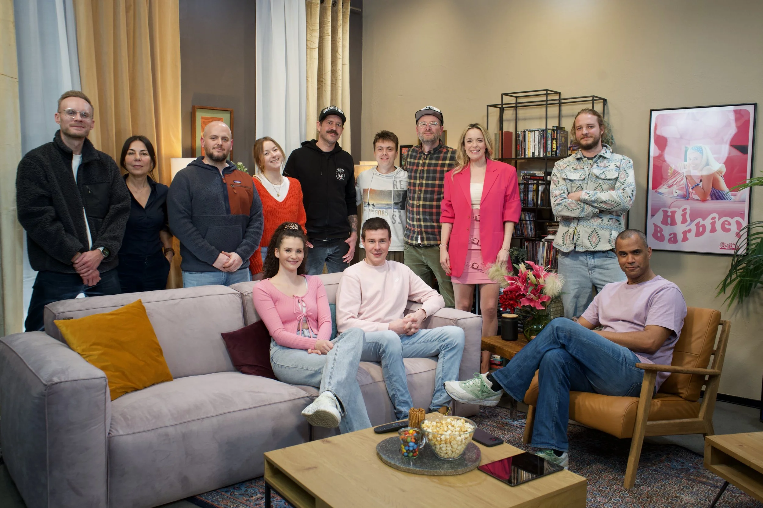 A group of people posing for a photo in the set of "Sky Talk", amongst them model Betty Taube, fashion designer Marina Hoermanseder and host Patrice Bouédibéla.
