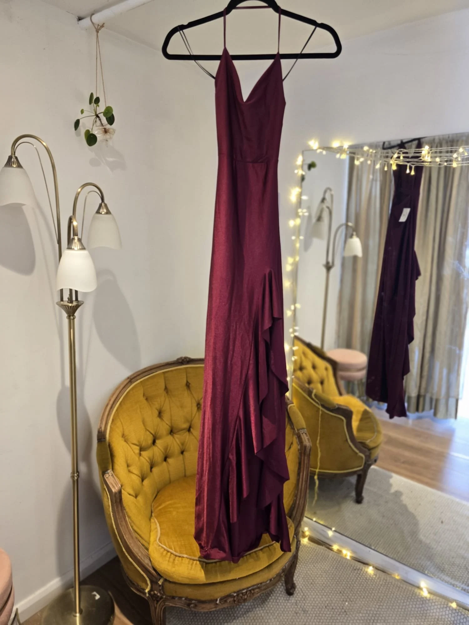 Burgundy mermaid gown with cascading hem ruffles and slim straps, photographed pre-tailoring for fit customisation at Brighton Alterations.